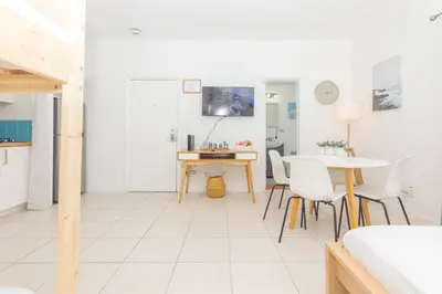 a white living room with a table and chairs at Ocean Villa in Miami Beach