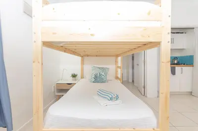 a bunk bed in a small room with a desk at Ocean Villa in Miami Beach