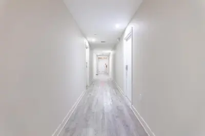 an empty hallway with white walls and wooden floors at Convention Center in Miami Beach