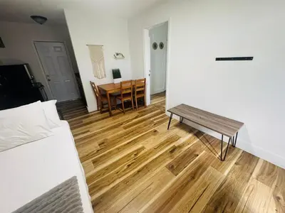 a room with a bed and a table and a bench at Cozy place Near Design District - 1 in Miami