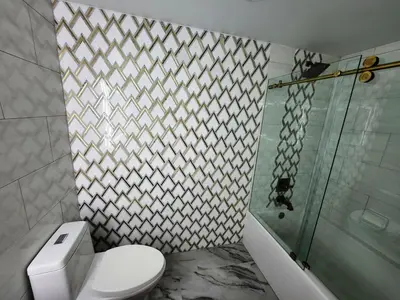 a bathroom with a toilet and a glass shower at Luxury Apt with Ocean View in Hallandale in Hallandale Beach