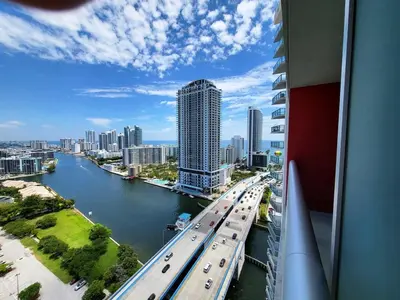 a view of a city with traffic on a bridge at Luxury Apt with Ocean View in Hallandale in Hallandale Beach