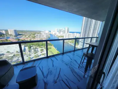 a balcony with a view of a river in a city at Luxury Apt with Ocean View in Hallandale in Hallandale Beach