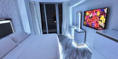 a bedroom with a white bed and a large window at The Royal Suite of Beachwalk 2b 2b Apmt in Hallandale Beach