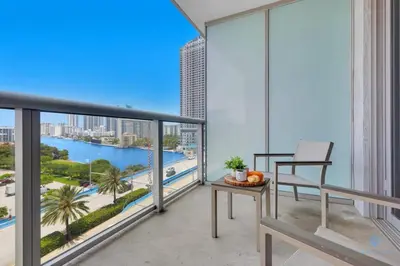 a balcony with a view of the water in a building at Unique 2BR Apartment Gym & Pool in Hallandale Beach