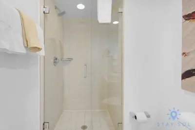 a bathroom with a shower with a glass door at Studio Miami Views - Amenities in Hallandale Beach