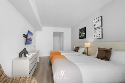 a bedroom with two beds and a sink in it at Ocean Views - Balcony & Resort Pool Paradise in Hollywood