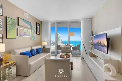 a living room with a couch and a view of the ocean at Ocean Views - Balcony & Resort Pool Paradise in Hollywood