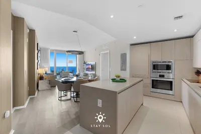 a kitchen and living room with a table and a dining room at Ocean Views - Balcony & Resort Pool Paradise in Hollywood