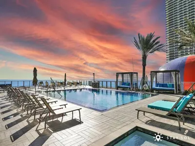 a swimming pool on a building with a sunset at Ocean Views - Balcony & Resort Pool Paradise in Hollywood