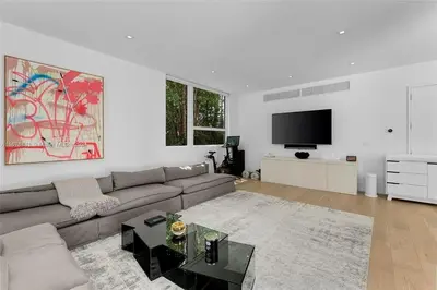 a living room with a couch and a flat screen tv at Villa Tranquil Luxe Modern Oasis with Private Pool in Miami Beach in Miami Beach