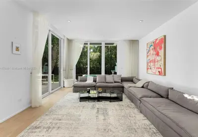 a living room with a couch and a table at Villa Tranquil Luxe Modern Oasis with Private Pool in Miami Beach in Miami Beach