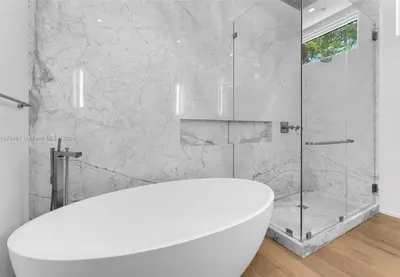 a bathroom with a white tub and a shower at Villa Tranquil Luxe Modern Oasis with Private Pool in Miami Beach in Miami Beach