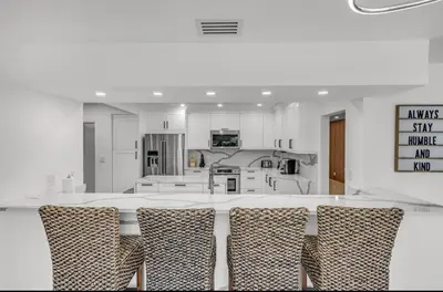a kitchen with a large table with chairs in it at Opulent Home with Sauna & Pool in Hollywood