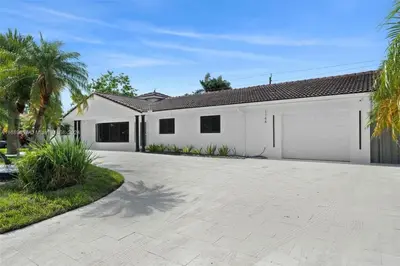 a large white house with a driveway at Opulent Home with Sauna & Pool in Hollywood