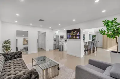 a living room with two couches and a table at Opulent Home with Sauna & Pool in Hollywood