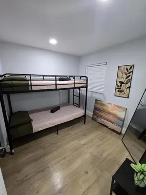 a room with two bunk beds and a wooden floor at Miami Urban Oasis - B in Miami