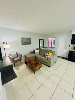 a living room with a couch and a table at Apartment in Hollywood close to shops & beach 108 in Hollywood