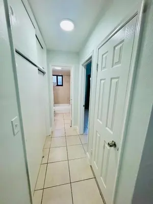 a hallway with a white door and a tile floor at Apartment in Hollywood close to shops & beach 108 in Hollywood