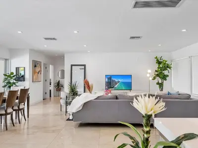 a living room with a couch and a table at luxury house by the water in Eastern Shores