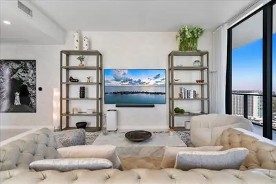 a living room with white furniture and a large window at POSH Ocean View Penthouse - Heated Pool, Gym, Office! 10mins Beach in Miami
