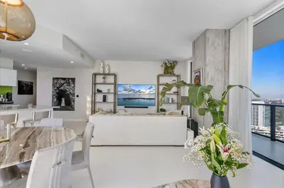 a kitchen and dining room with a table and chairs at POSH Ocean View Penthouse - Heated Pool, Gym, Office! 10mins Beach in Miami