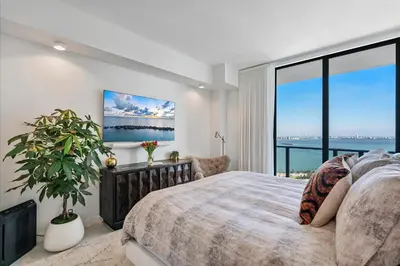 a bedroom with a large bed and a large window at POSH Ocean View Penthouse - Heated Pool, Gym, Office! 10mins Beach in Miami