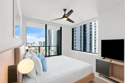 a bedroom with a bed and a flat screen tv at New 26th floor amazing view 2BR-2BA in Miami