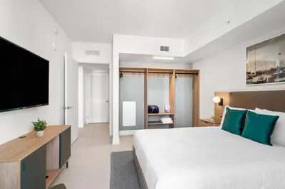 a bedroom with a large bed and a flat screen tv at New 26th floor amazing view 2BR-2BA in Miami