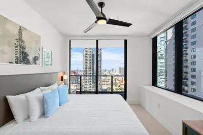 a bedroom with a large bed with blue pillows at New 26th floor amazing view 2BR-2BA in Miami