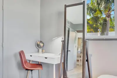 a bathroom with a mirror and a desk and a chair at Newly Renovated 1BR Condo Near South Beach in Miami Beach