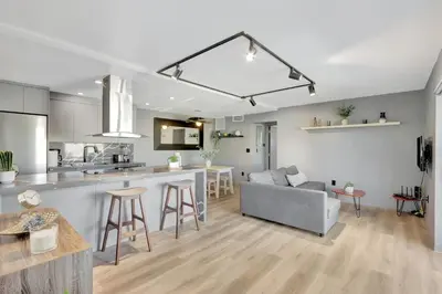 a kitchen and living room with a couch and a table at Newly Renovated 1BR Condo Near South Beach in Miami Beach