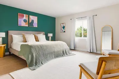 a bedroom with a bed and a green wall at Lux 6BR Villa with Pool, King Beds and Top Amenities in Miami
