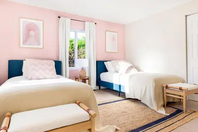 two beds in a room with pink and white at Lux 6BR Villa with Pool, King Beds and Top Amenities in Miami