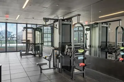 a gym with several machines and a large window at NEW Suite Downtown Miami - Amazing view 27th floor in Miami