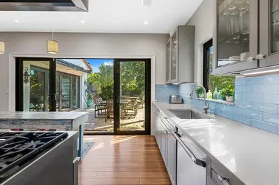 a kitchen with white countertops and a view of a patio at Beach Estate Las Olas Beach Best Location in Fort Lauderdale
