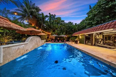 a swimming pool in front of a house at Beach Estate Las Olas Beach Best Location in Fort Lauderdale