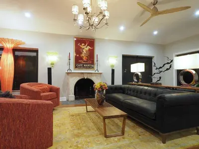 a living room with a black couch and a fireplace at Beach Estate Las Olas Beach Best Location in Fort Lauderdale
