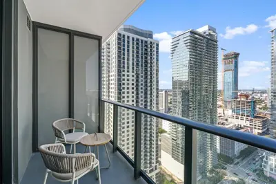 a balcony with two chairs and a table at Stunning Views Dwntwn Miami 2BR Unit - Floor 28th in Miami