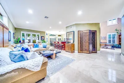 a large living room with a couch and a table at 5BR Luxury Mins to Las Olas, Shops and Beach in Fort Lauderdale