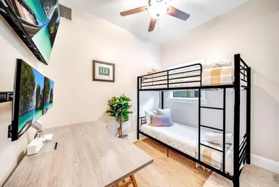 a bedroom with a bunk bed and a desk at 5BR Luxury Mins to Las Olas, Shops and Beach in Fort Lauderdale