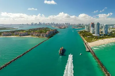 a boat in the water in front of a city at Stylish Studio - Amazing Amenities & Pool in Miami