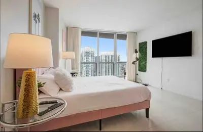 a bedroom with a large bed and a television at Icon Brickell Amazing Ocean View in Miami