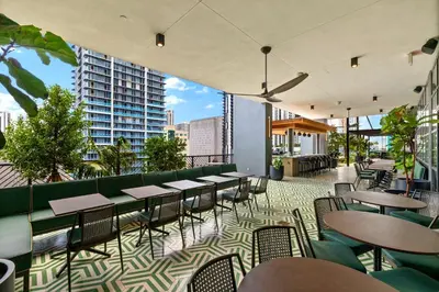 a restaurant with tables and chairs on a balcony at On The 49th Floor! Condo on Highest & Free Parking in Miami