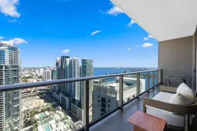 an apartment balcony with a view of the city at On The 49th Floor! Condo on Highest & Free Parking in Miami