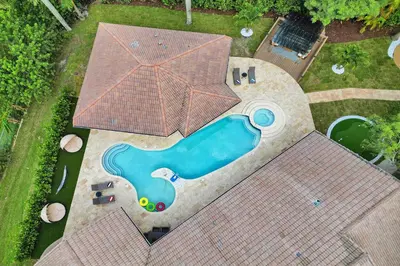 an overhead view of a swimming pool on a house at The Grand Luxe 8BR Villa w POOL and basketball in Pembroke Pines