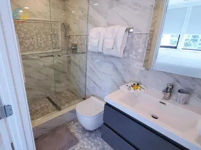a bathroom with a shower and a toilet and a sink at Alexander 1001 in Miami Beach