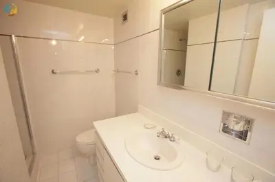 a bathroom with a sink and a toilet and a mirror at Alexander 1010 in Miami Beach
