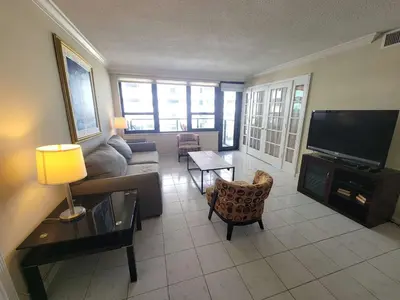 a living room with a couch and a television at Alexander 1010 in Miami Beach