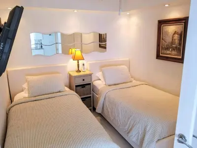 a bedroom with two beds and a lamp on a table at Alexander 1101 in Miami Beach